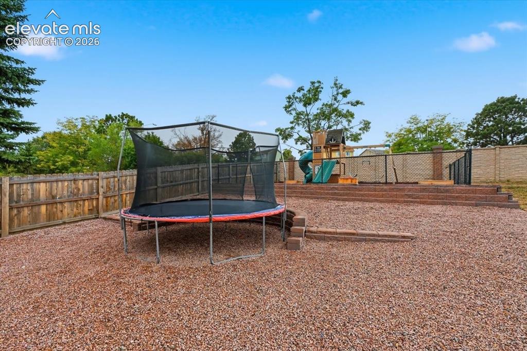 Image 45 of 50: Custom play area! Trampoline and play set included!