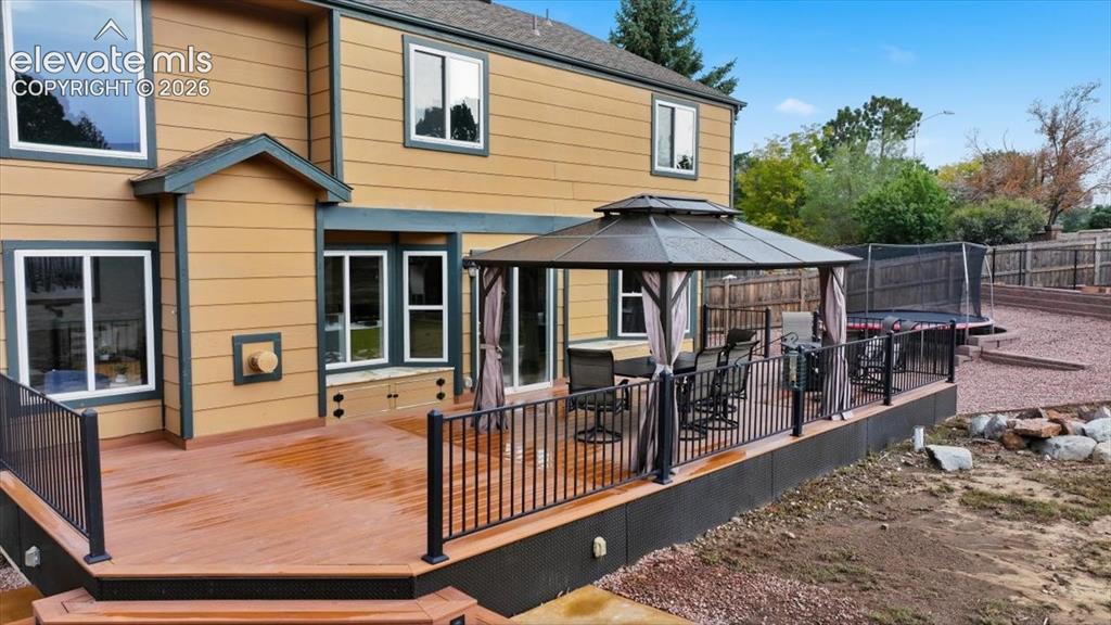 Image 6 of 50: Gorgeous and huge newer composite deck with granite topped benches and perg