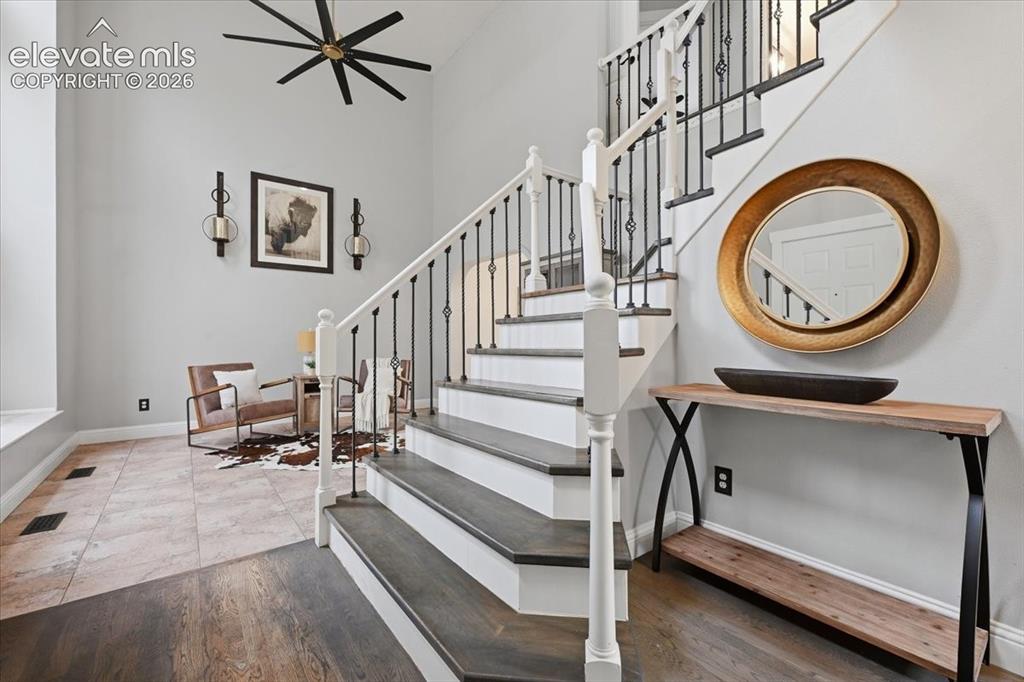 Image 7 of 50: Charming entry with wood stairs and painted risers!  Upgraded fans througho