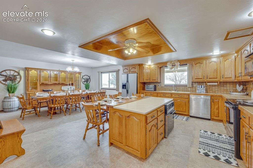 Image 10 of 20: Kitchen with island, additional seating, and attached dining room