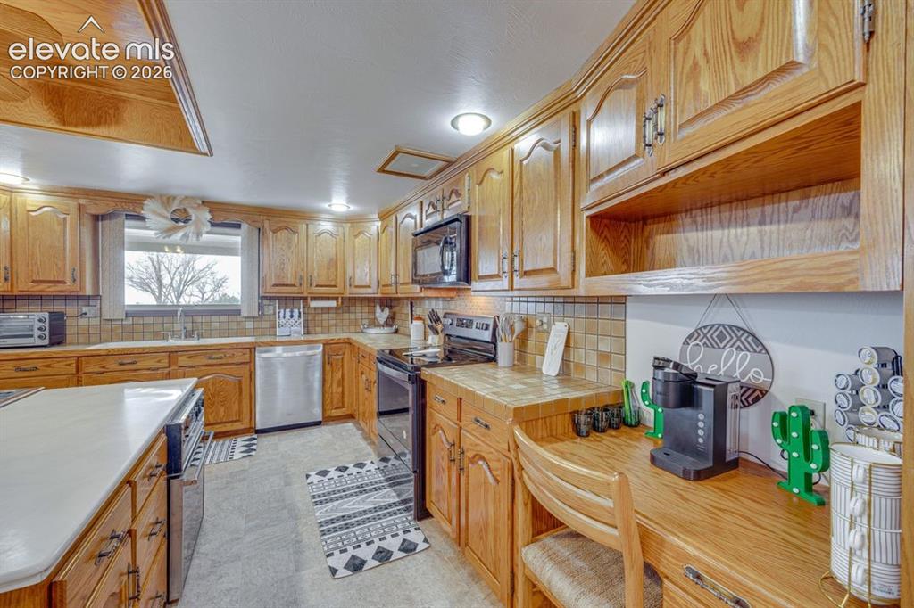Image 12 of 20: Kitchen with additional desk area
