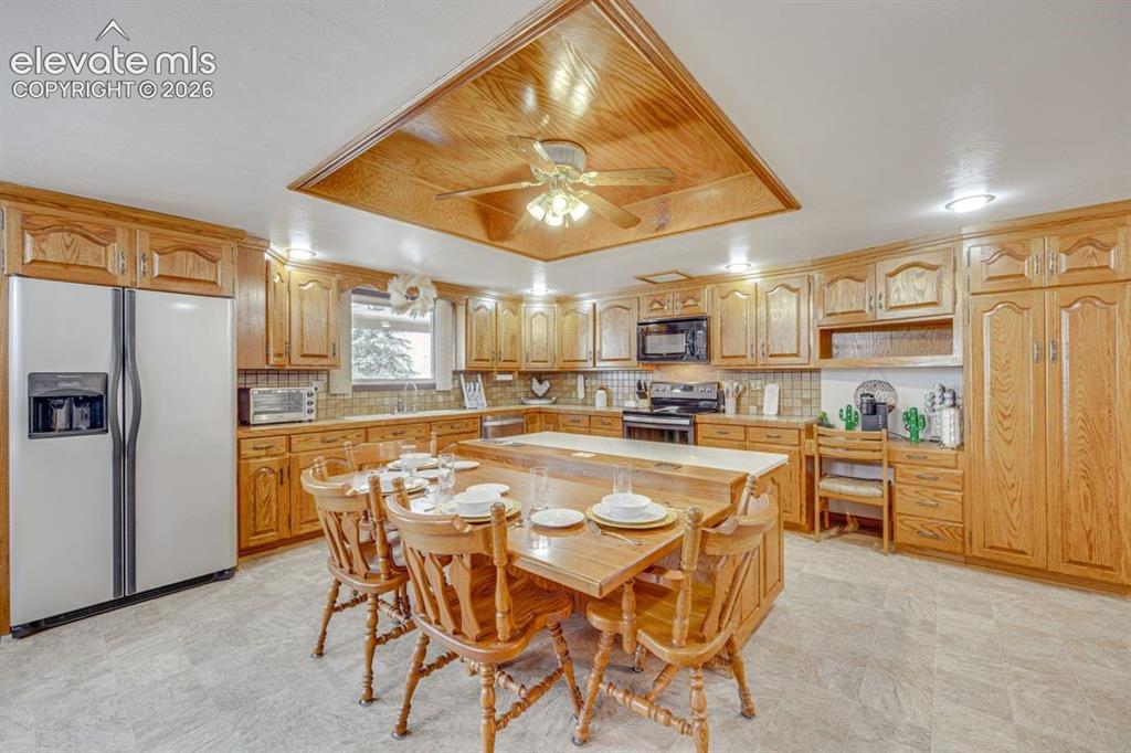 Image 13 of 20: View of full kitchen with additional seating at island