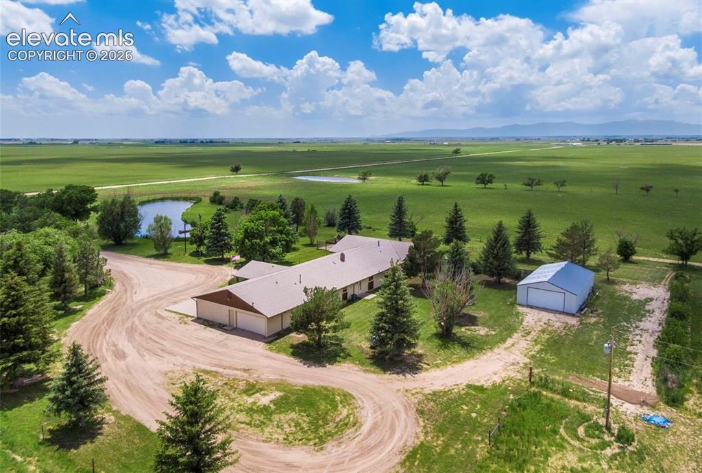 Image 3 of 20: Aeriel view including pond, house and outbuilding