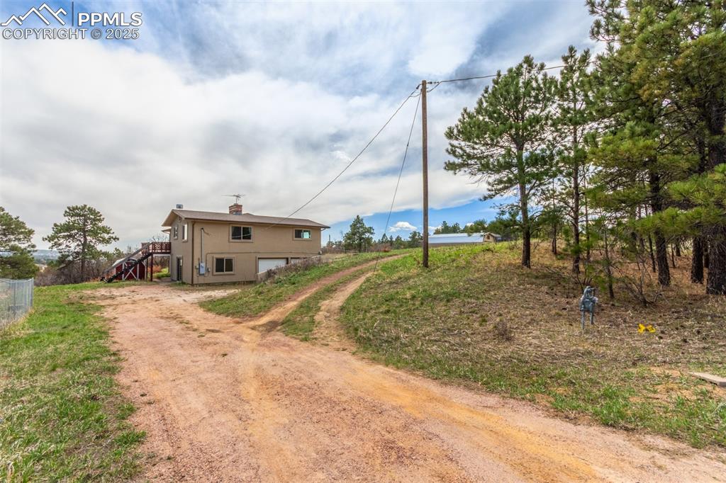 Image 2 of 44: As seen from Draco Drive. You can pull into the bottom level of the home to
