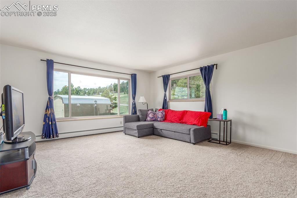 Image 9 of 44: Large main level living room with lots of natural light.