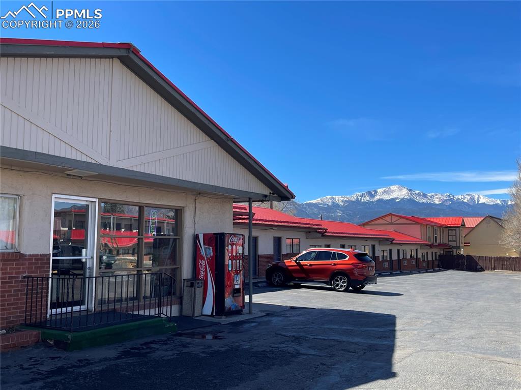 Image 2 of 6: View of side of home featuring a mountain view and uncovered parking