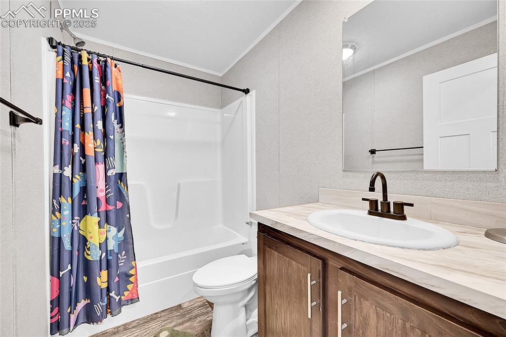 Image 10 of 12: Bathroom with vanity, ornamental molding, shower / bath combination with cu