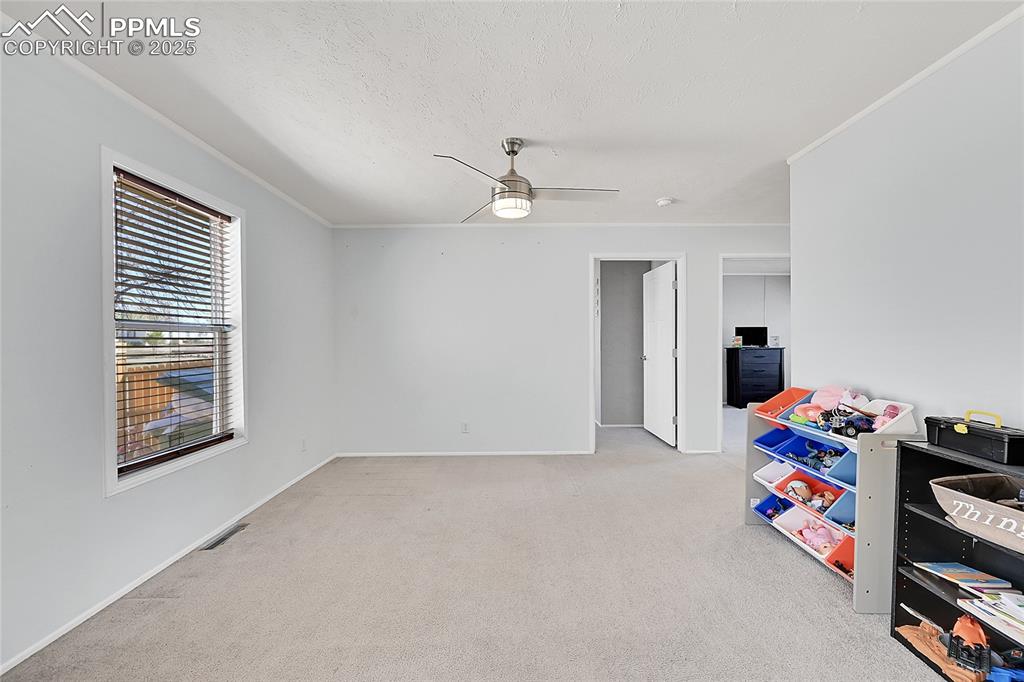 Image 5 of 12: Recreation room featuring visible vents, ceiling fan, a textured ceiling, c