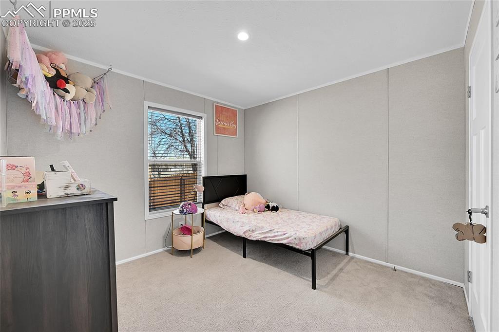 Image 8 of 12: Carpeted bedroom featuring baseboards