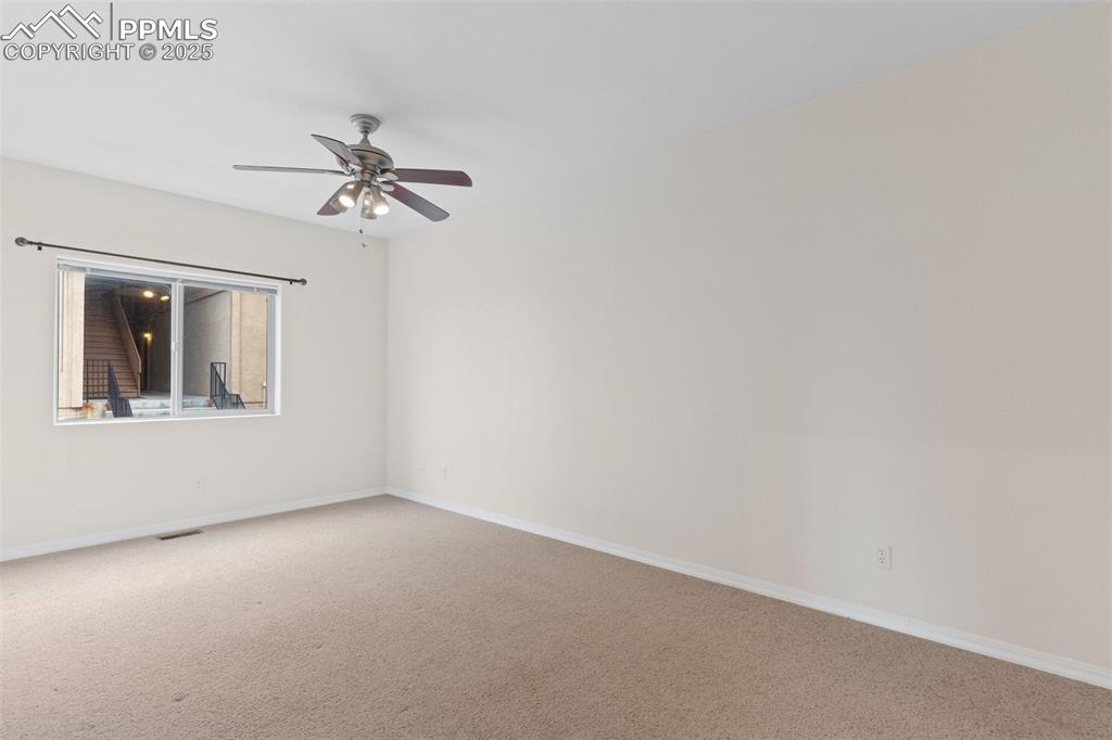 Image 15 of 27: Empty room featuring carpet and ceiling fan