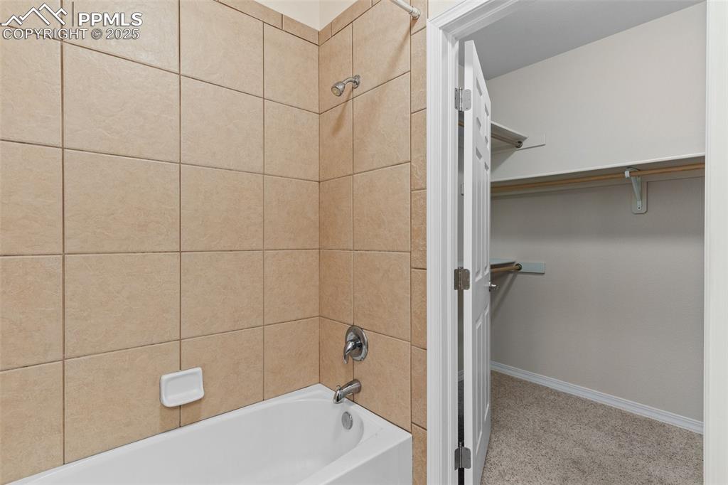 Image 19 of 27: Full bathroom featuring bathing tub / shower combination and a spacious clo