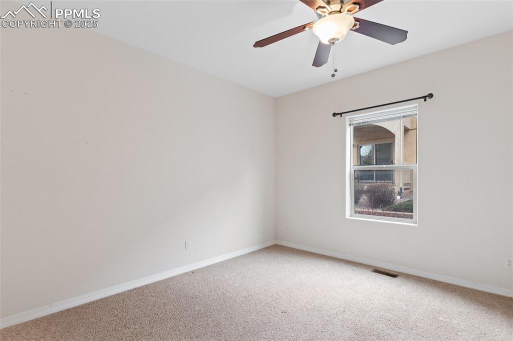 Image 21 of 27: Spare room with carpet and a ceiling fan
