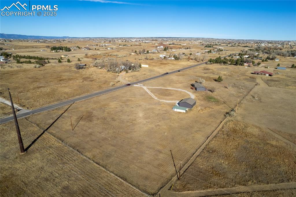 Image 37 of 49: Aerial view of sparsely populated area featuring a desert landscape