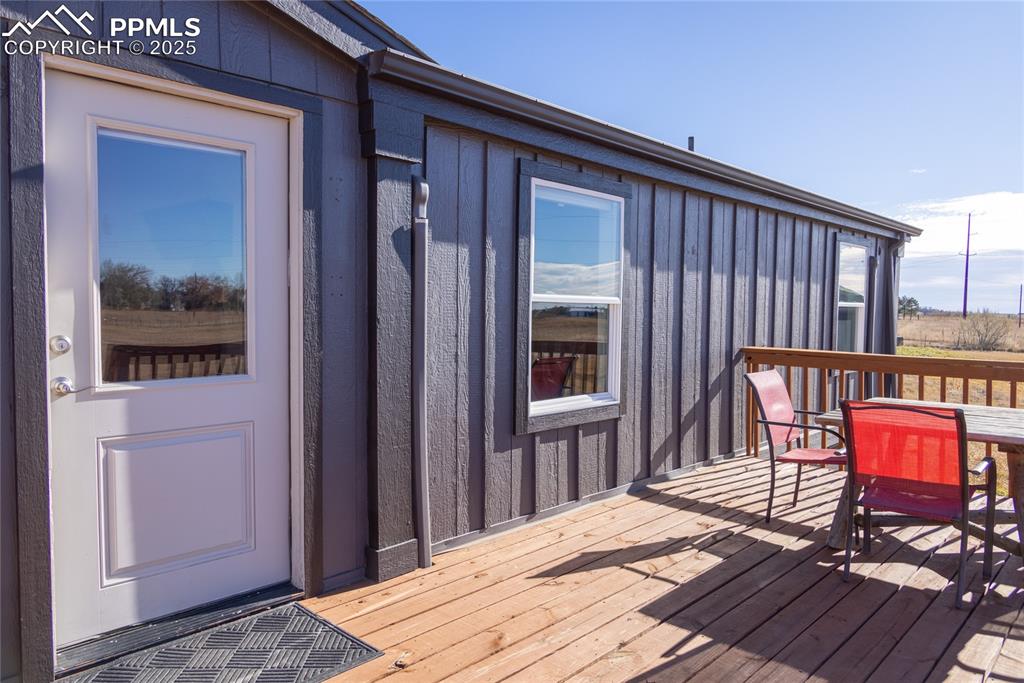 Image 43 of 49: Wooden terrace featuring outdoor dining area