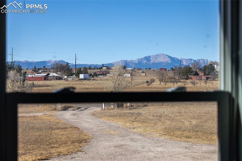 Image 47 of 49: View of dirt / gravel road with a mountain view and a view of countryside