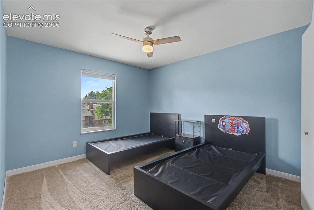 Image 22 of 30: Room featuring a neutral carpet, light blue walls, and a window with outdoo
