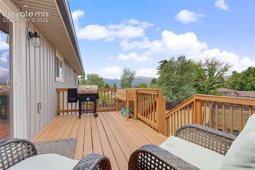 Image 28 of 30: Expansive wood-finish deck with wooden railings, providing generous outdoor