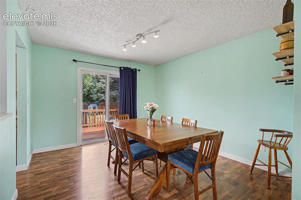Image 8 of 30: Dining area featuring wood-finish flooring