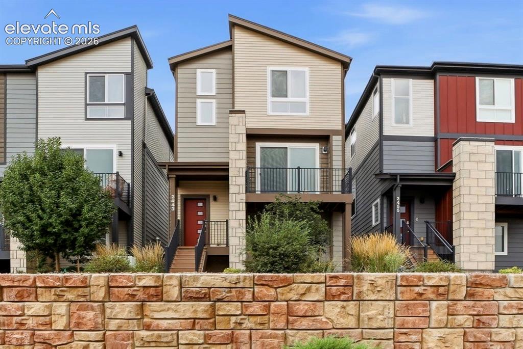 Image 1 of 25: Modern exterior architecture featuring a prominent stone facade, multiple b
