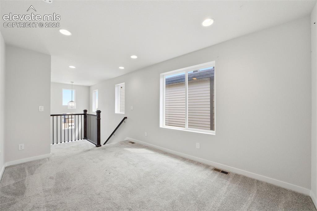 Image 13 of 23: Recessed ceiling lighting, light gray wall paint, and white trim