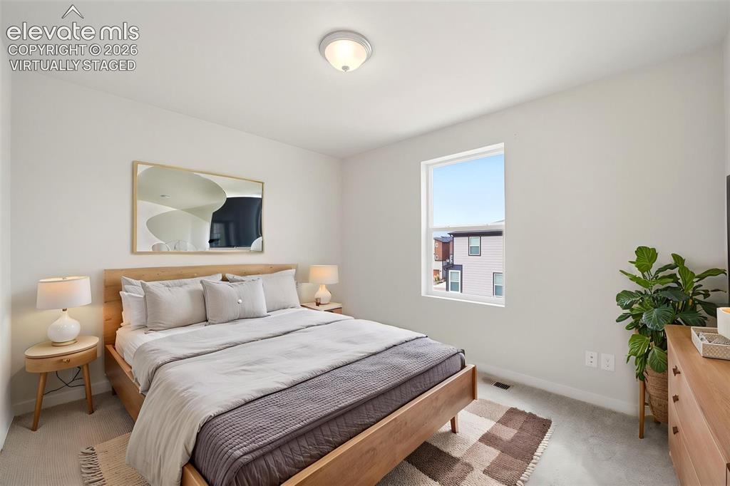 Image 16 of 23: Virtually Staged -Bedroom 2 - Soft carpet flooring, a window offering natur