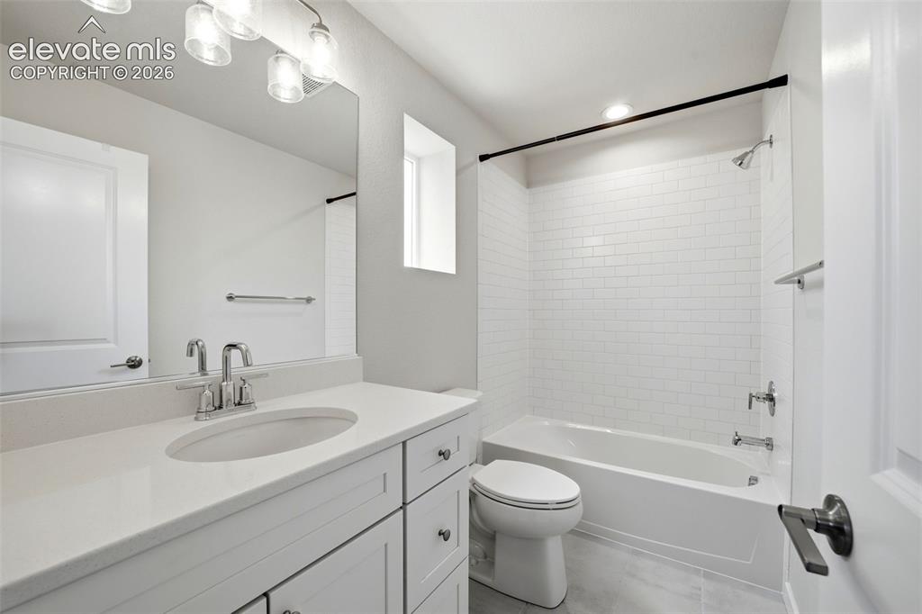Image 17 of 23: Bathroom 2 - White vanity with integrated sink, polished chrome faucet, and
