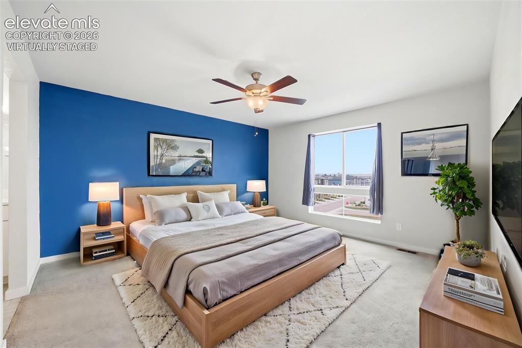 Image 20 of 23: Virtually Staged - Spacious primary bedroom suite featuring an accent wall 