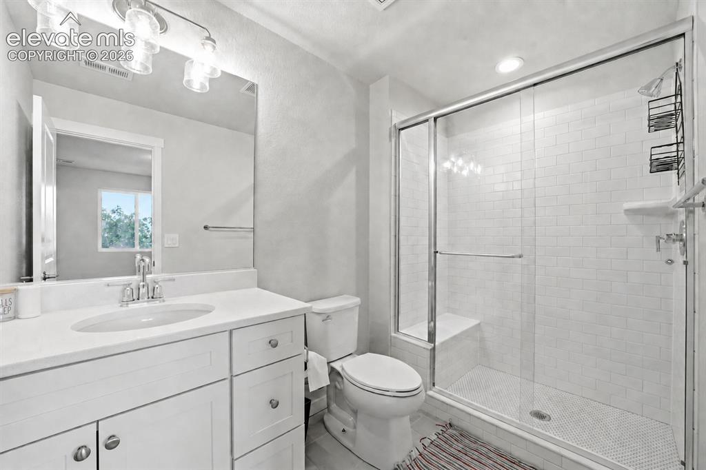 Image 3 of 23: Bathroom 3 - White vanity with a single basin sink, white countertop, and c