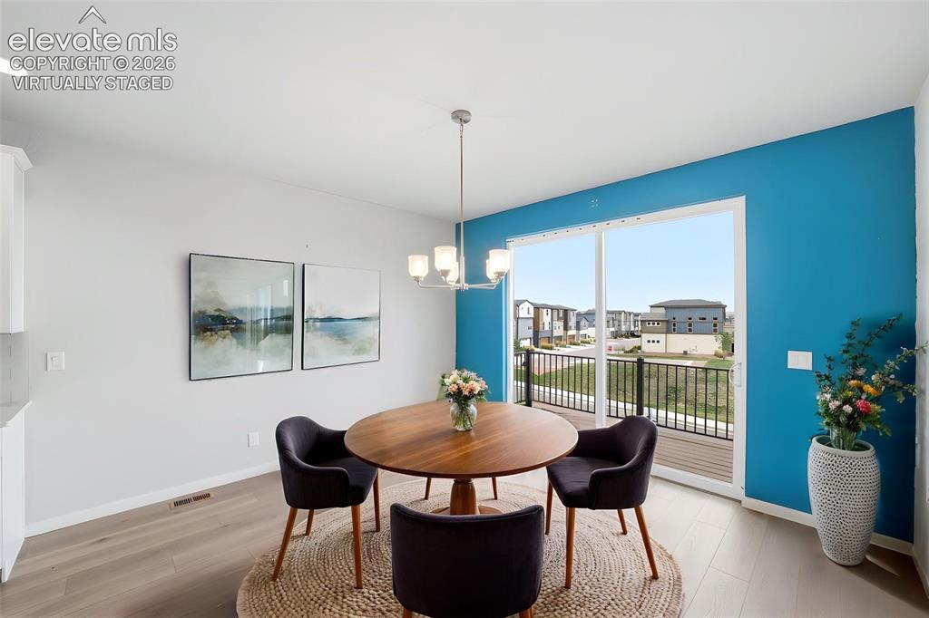 Image 4 of 25: Virtually Staged - Sliding glass door, wood-finish flooring, recessed ceili