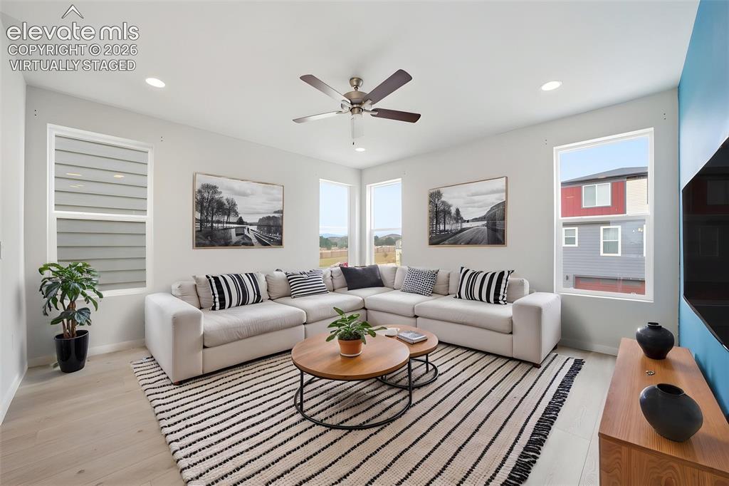 Image 6 of 23: Virtually Staged -Recessed lighting, light-toned wood-finish flooring, and