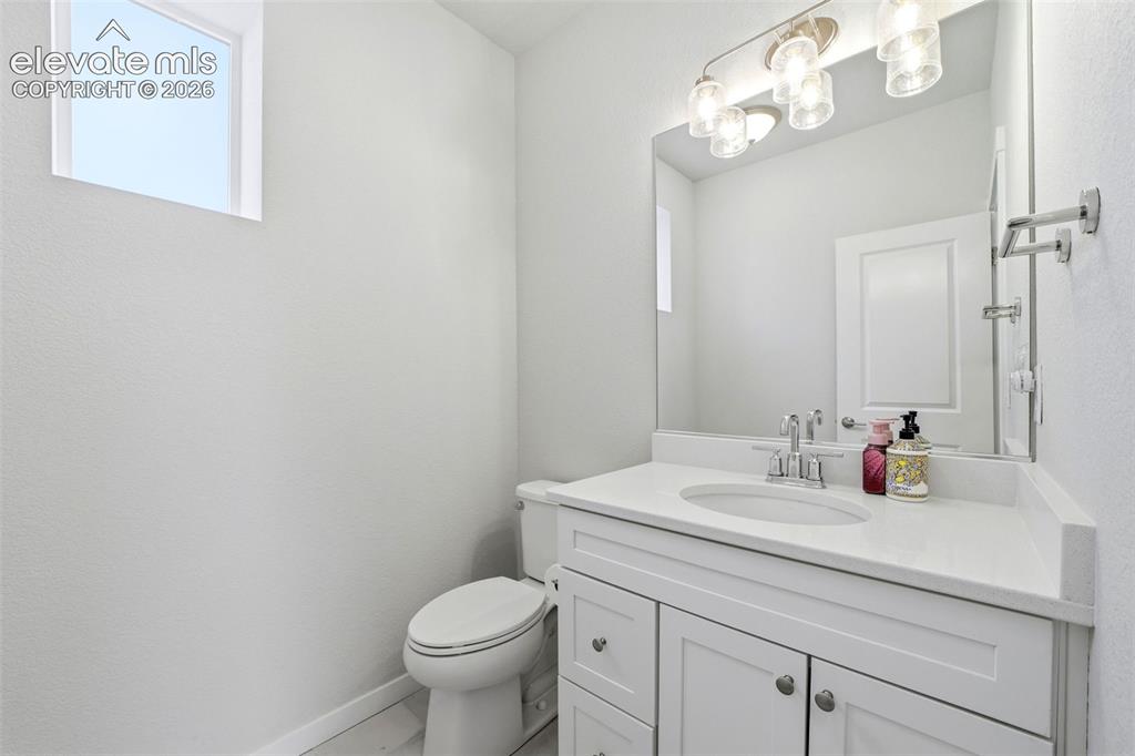 Image 7 of 23: Bathroom Main level 1/2 bath - Vanity with white shaker cabinetry, an integ