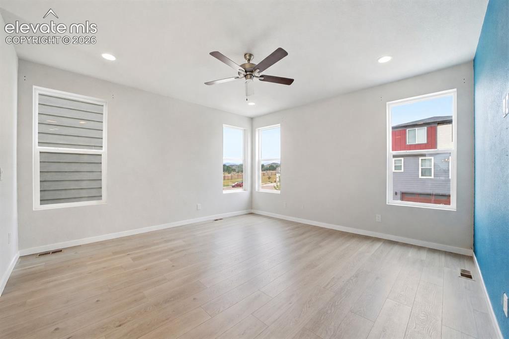 Image 8 of 25: Recessed lighting, ceiling fan, multiple windows, light-toned walls, and wo