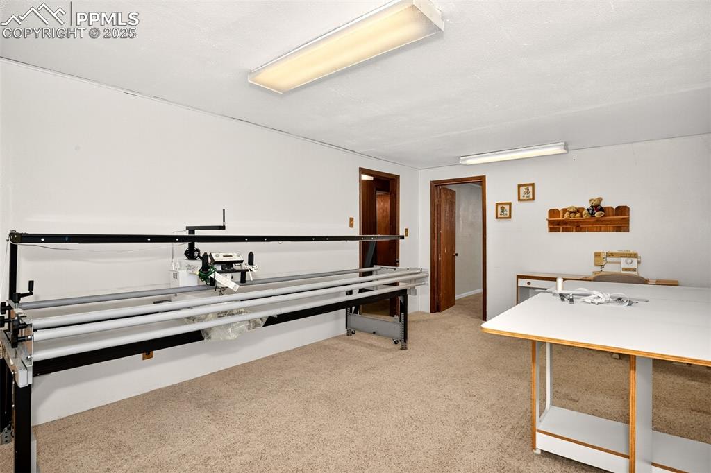 Image 18 of 36: Head downstairs to a large family, game or crafting room