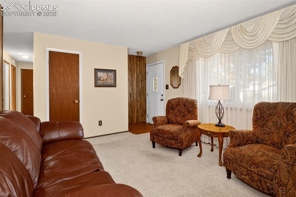 Image 3 of 36: Enter the home into a front living room with large front window