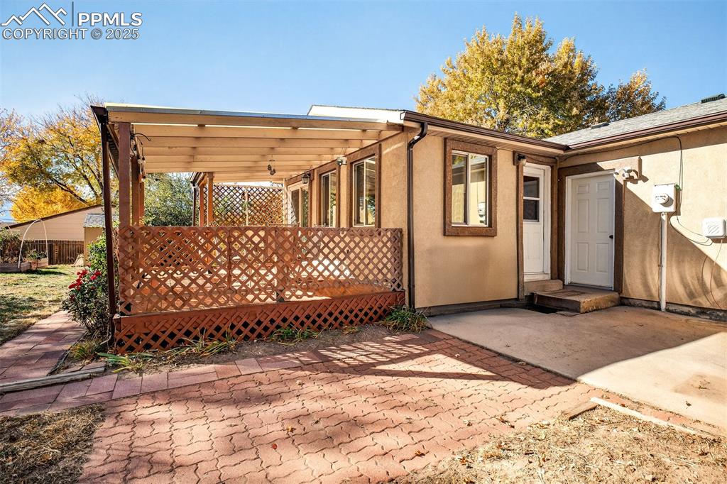 Image 32 of 36: Around the otherside of the deck is the second dining area access and a doo