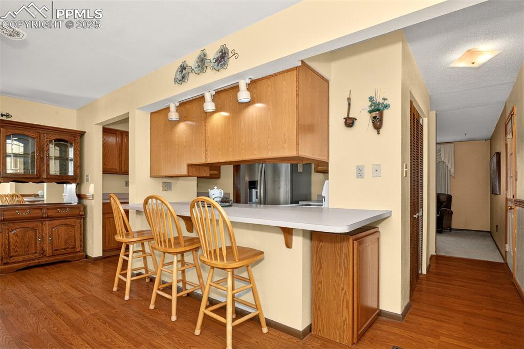 Image 5 of 36: Central kitchen with a large breakfast bar facing the dining area