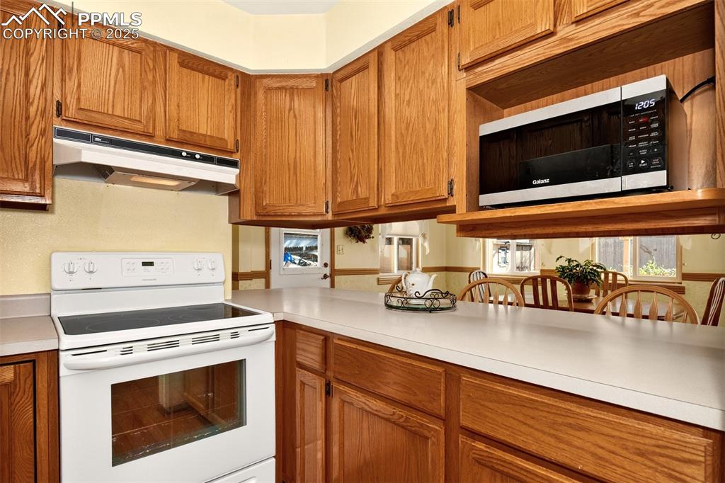 Image 9 of 36: Kitchen offers great cabinet storage including a microwave oven shelf allow
