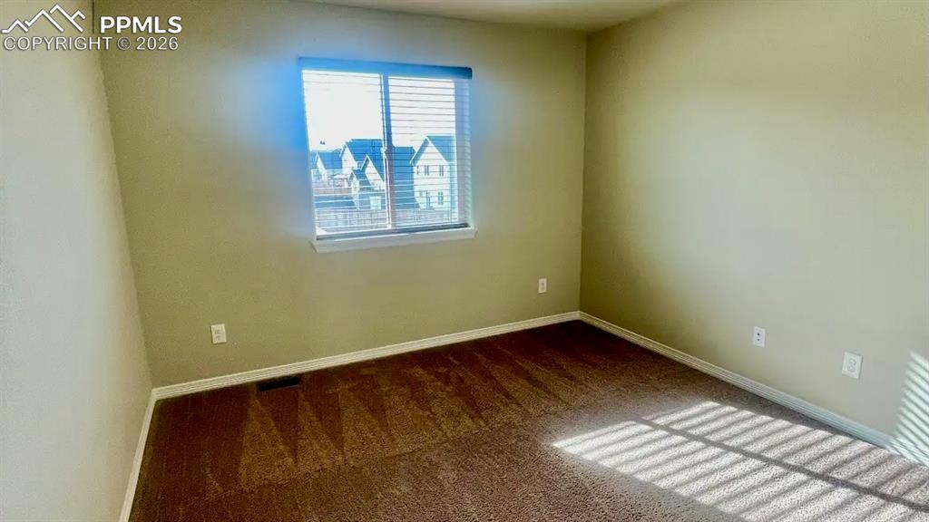 Image 10 of 15: Bright upper-level bedroom