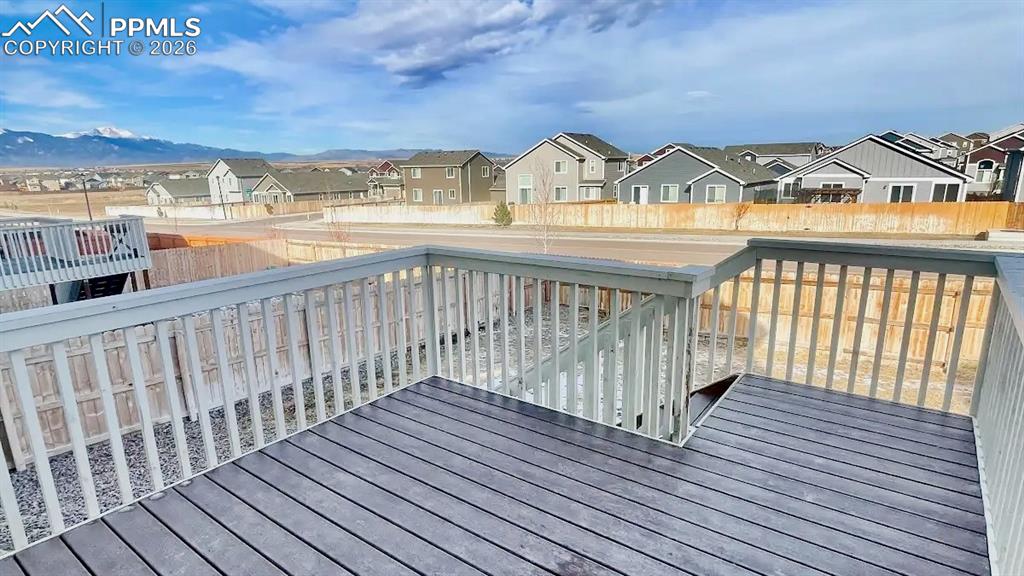 Image 14 of 15: Spacious elevated deck overlooking the fenced backyard.