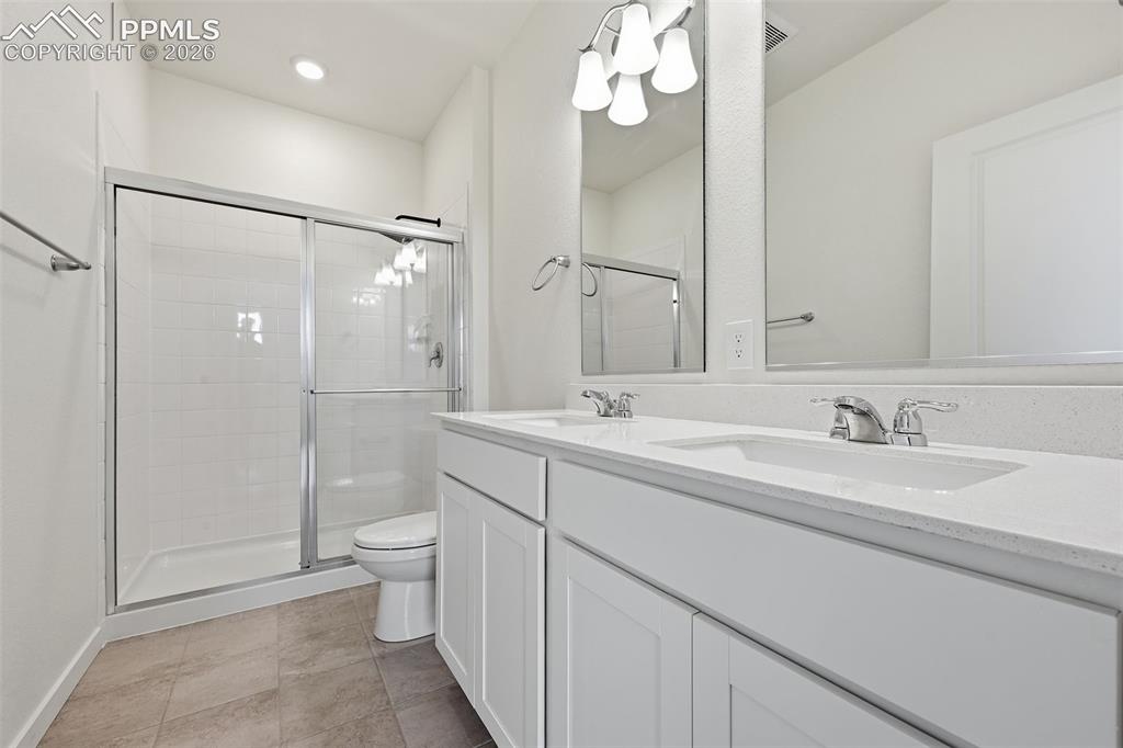 Image 12 of 23: Light-filled room featuring neutral wall paint, gray carpet flooring, a sin