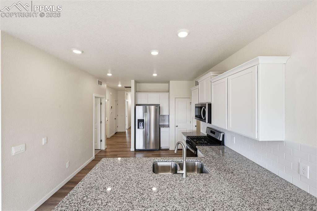Image 2 of 23: Kitchen featuring a large island with a double basin sink, stainless steel 
