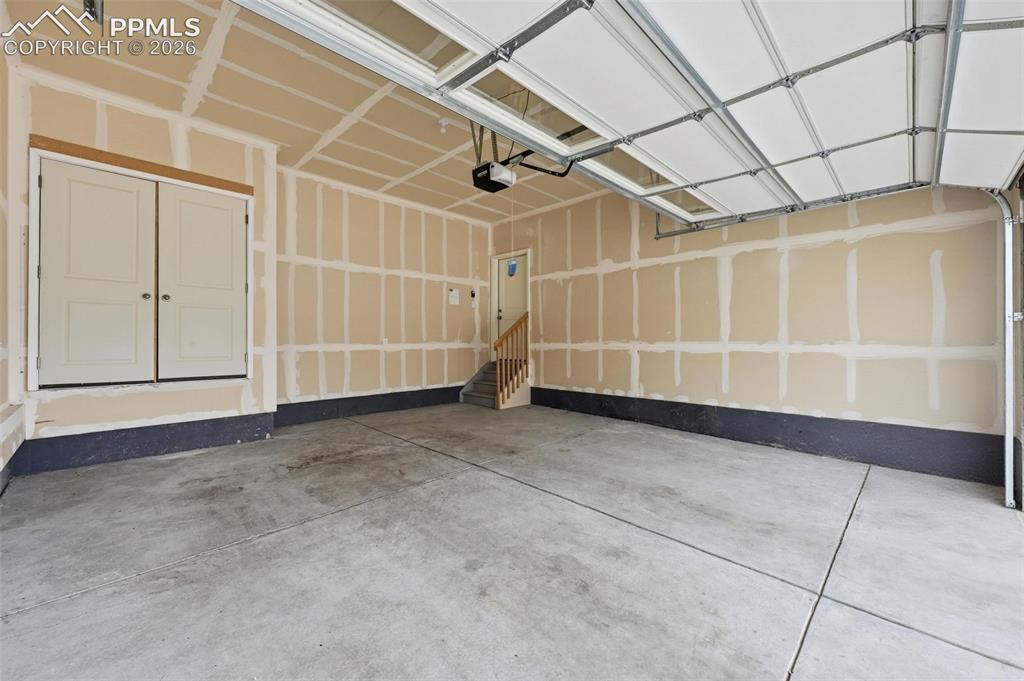 Image 20 of 23: Dedicated laundry area featuring a white front-loading washer and dryer set