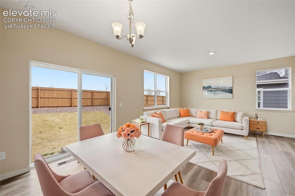 Image 5 of 23: Virtually Staged Photo. Open-concept living space featuring wood-finish flo