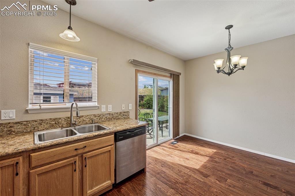 Image 12 of 39: Kitchen opens to Dining Area with walkout to patio - this functional space 