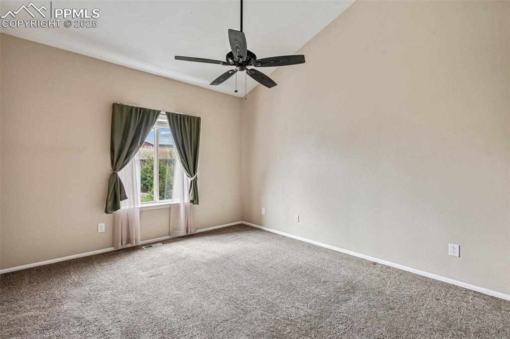 Image 14 of 39: Large Primary bedroom with ceiling fan and attached bath