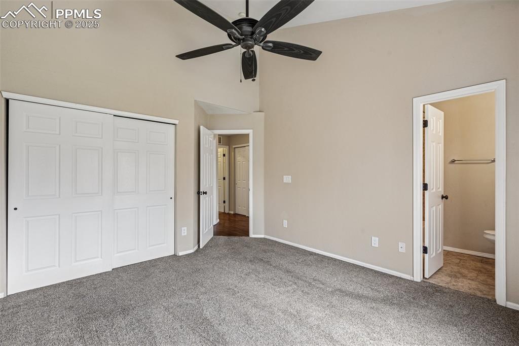 Image 15 of 39: Main Level primary bedroom featuring Large closet, high ceiling, ceiling fa