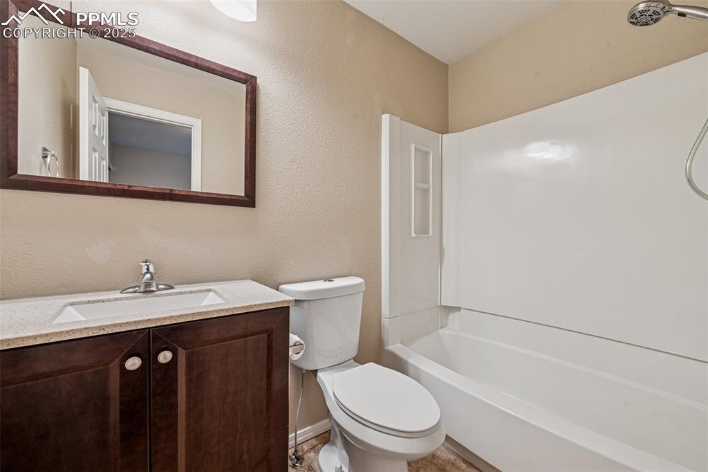 Image 23 of 39: Full bath with vanity and bathtub / shower combination