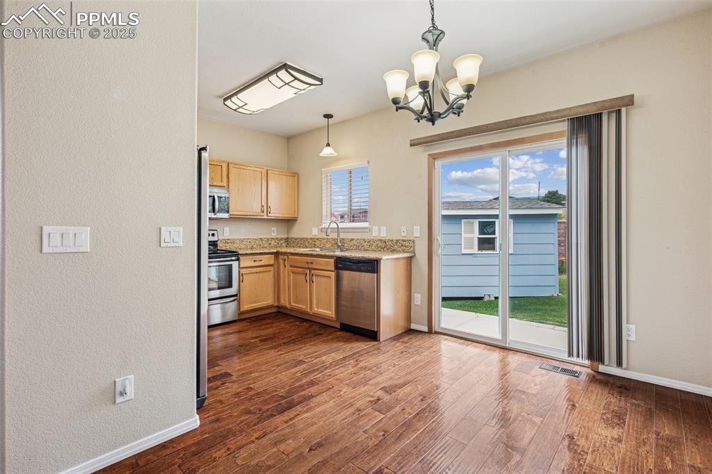 Image 9 of 39: Dining Area and Kitchen with walkout to large patio for entertaining