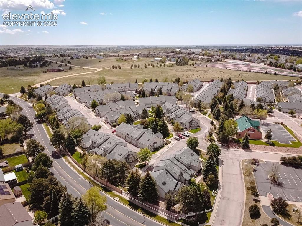Image 38 of 38: Aerial perspective showcasing a residential community with mature landscapi