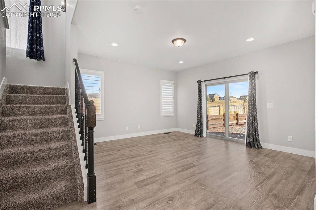 Image 10 of 20: Bright and sunny living area with can lighting and slider to back yard and 